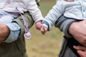 need for intimacy represented by children touching hands